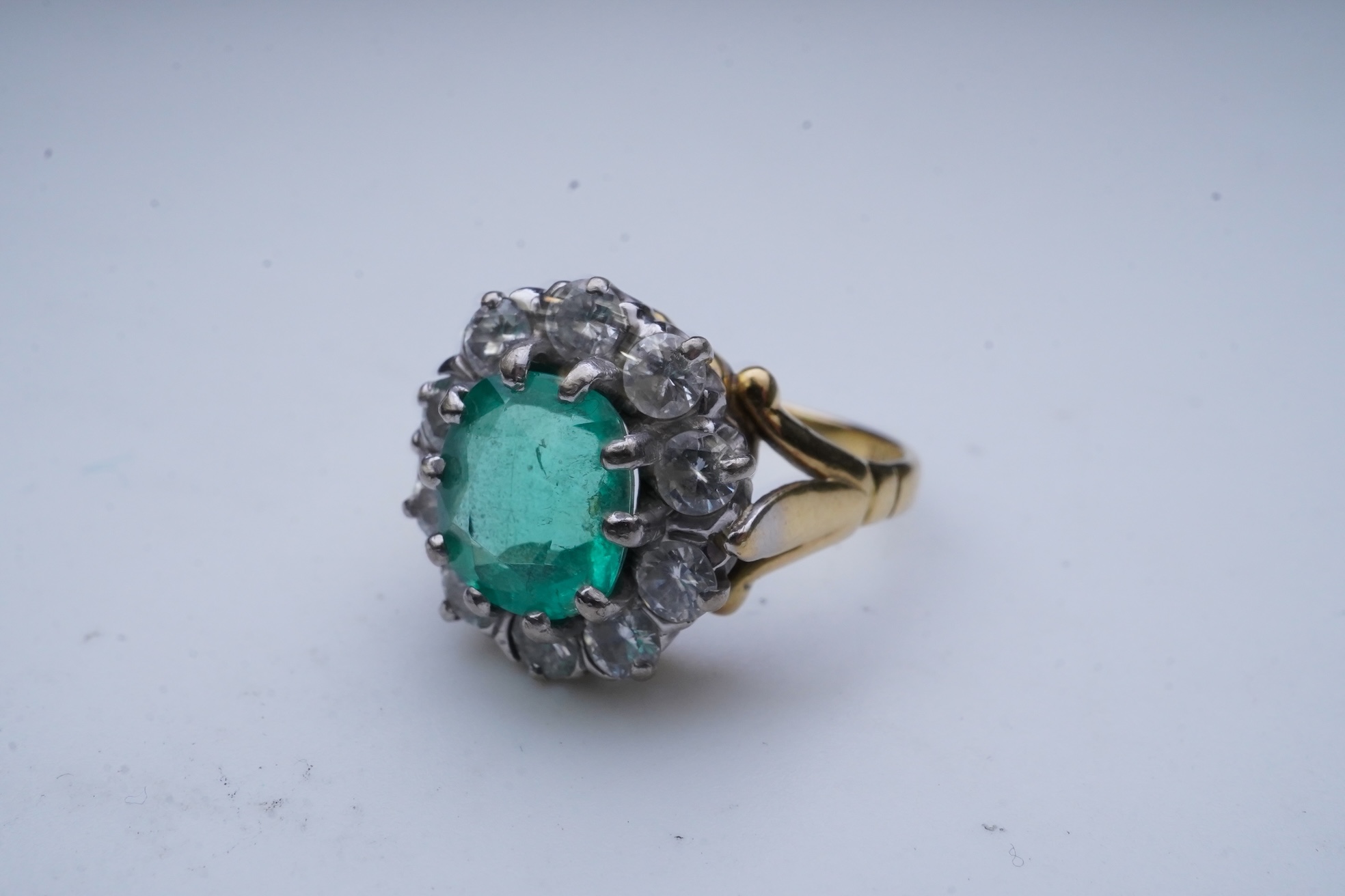 An emerald and diamond ring